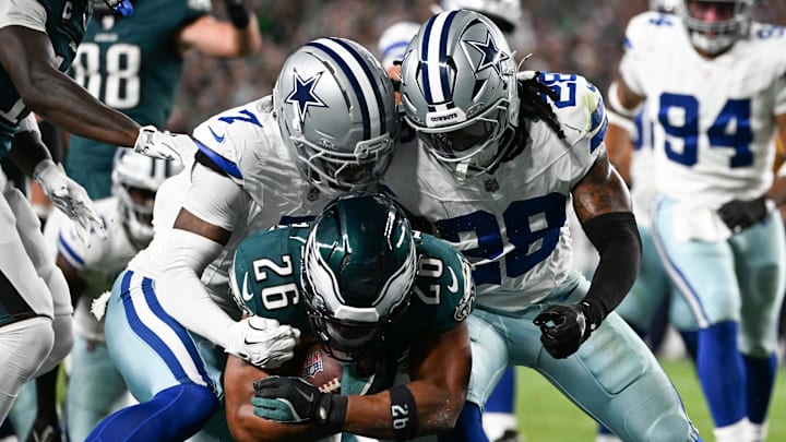 Philadelphia Eagles RB Saquon Barkley carries the ball for a TD defended by Dallas Cowboys CB Trevon Diggs and S Malik Hooker.