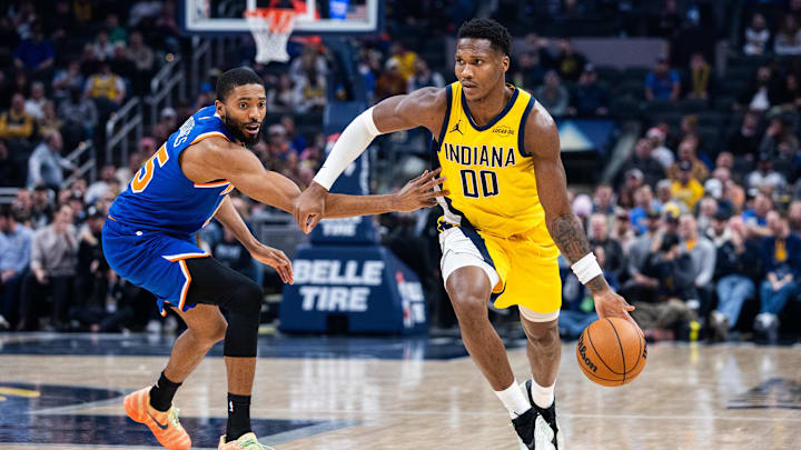 Dec 18, 2025; Indianapolis, Indiana, USA;  Indiana Pacers guard/forward Bennedict Mathurin (00) dribbles the ball while New York Knicks guard/forward Mikal Bridges (25) defends in the first half at Gainbridge Fieldhouse. Mandatory Credit: Trevor Ruszkowski-Imagn Images