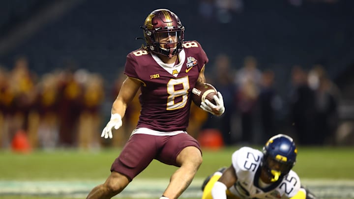 Dec 28, 2021; Phoenix, AZ, USA; Minnesota Golden Gophers running back Ky Thomas (8) runs the ball against the West Virginia Mountaineers in the second half of the Guaranteed Rate Bowl at Chase Field. Mandatory Credit: Mark J. Rebilas-Imagn Images