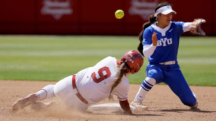 Oklahoma catcher Kinzie Hansen (9) slides to second as the ball goes past BYU shortstop Ailana Agbayani (50) in the fifth inning of a college softball game between the University of Oklahoma Sooners (OU) and BYU at Love's Field in Norman, Okla., Saturday, April 13, 2024. Oklahoma won 7-3. Oklahoma catcher Kinzie Hansen (9) slides to second as the ball goes past BYU shortstop Ailana Agbayani (50) in the fifth inning of a college softball game between the University of Oklahoma Sooners (OU) and BYU at Love's Field in Norman, Okla., Saturday, April 13, 2024. Oklahoma won 7-3.