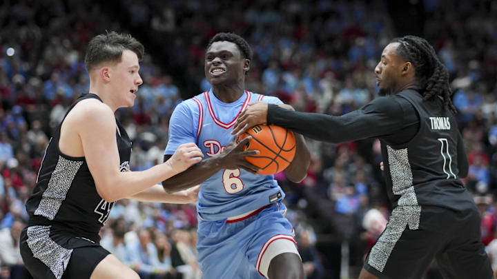 Dayton Flyers guard Enoch Cheeks drives to the basket against Cincinnati Bearcats guard Simas Lukosius and guard Day Day Thomas in the first half at Heritage Bank Center. Dayton Flyers guard Enoch Cheeks drives to the basket against Cincinnati Bearcats guard Simas Lukosius and guard Day Day Thomas in the first half at Heritage Bank Center.