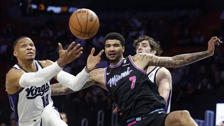 Dec 6, 2025; Miami, Florida, USA;   Sacramento Kings guard Russell Westbrook (18) and Miami Heat center Kel'el Ware (7) go for a rebound during the first half at Kaseya Center. Mandatory Credit: Rhona Wise-Imagn Images