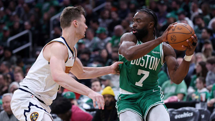 Mar 2, 2025; Boston, Massachusetts, USA; Boston Celtics forward Jaylen Brown (7) defended by Denver Nuggets forward Christian Braun (0) during the second half at TD Garden. Mandatory Credit: Paul Rutherford-Imagn Images