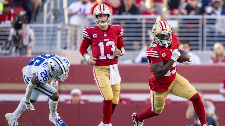 October 8, 2023; Santa Clara, California, USA; San Francisco 49ers wide receiver Deebo Samuel (19) runs the football against Dallas Cowboys cornerback DaRon Bland (26) in front of 49ers quarterback Brock Purdy (13) during the first quarter at Levi's Stadium. Mandatory Credit: Kyle Terada-Imagn Images