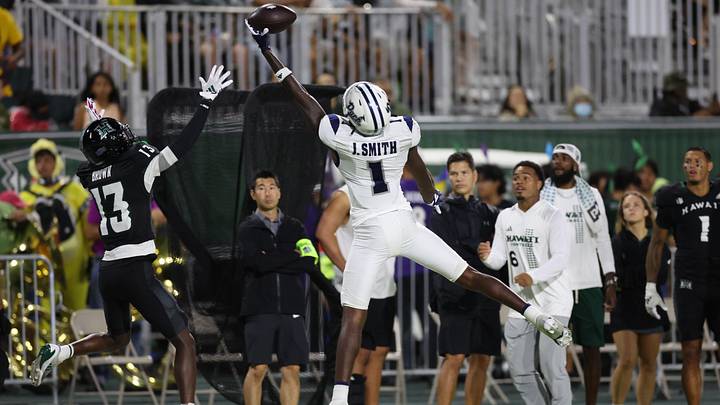 Nevada Wolf Pack wide receiver Jaden Smith (1) attempts to make a catch over a Hawaii Rainbow Warriors defensive back.