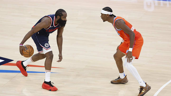 Nov 11, 2024; Oklahoma City, Oklahoma, USA; Los Angeles Clippers guard James Harden (1) dribbles the ball down the court as Oklahoma City Thunder guard Shai Gilgeous-Alexander (2) defends during the first quarter at Paycom Center. Mandatory Credit: Alonzo Adams-Imagn Images