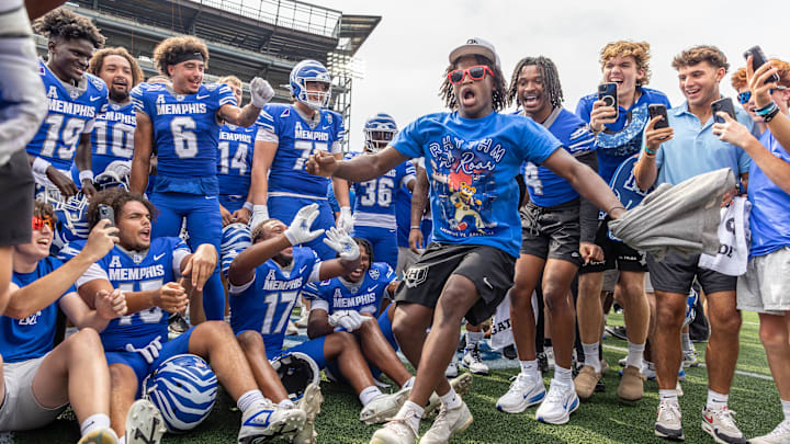 Sep 20, 2025; Memphis, Tennessee, USA; Memphis Tigers players and fans celebrate after winning the game against the Arkansas Razorbacks at Simmons Bank Liberty Stadium. Mandatory Credit: Wesley Hale-Imagn Images