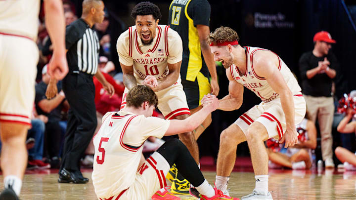 Nebraska guards Jamarques Lawrence (10) and Sam Hoiberg help forward Braden Frager after he was fouled on a three-point basket by Oregon during the second half at Pinnacle Bank Arena.