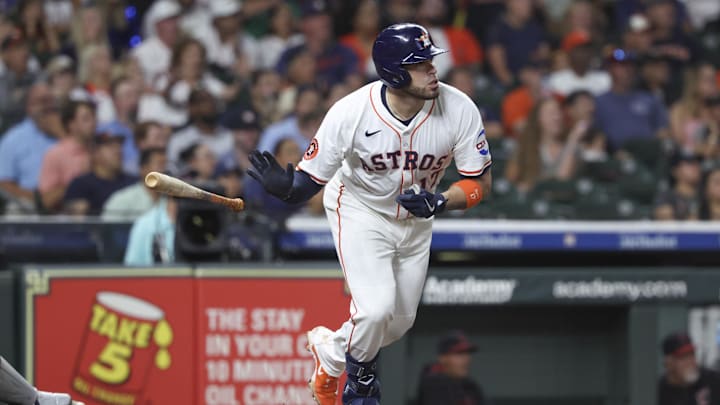 Jul 8, 2025; Houston, Texas, USA; Houston Astros first baseman Victor Caratini (17) drives in a run with a sacrifice fly during the fifth inning against the Cleveland Guardians at Daikin Park. Mandatory Credit: Troy Taormina-Imagn Images