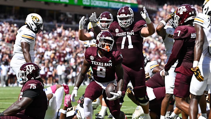 Oct 5, 2024; College Station, Texas, USA; Texas A&M Aggies running back Le'Veon Moss (8) reacts after scoring a touchdown in the first half against the Missouri Tigers at Kyle Field. Mandatory Credit: Maria Lysaker-Imagn Images. 