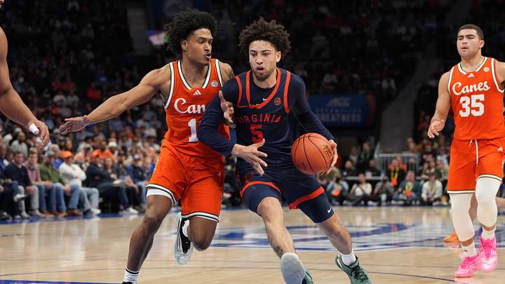 Mar 13, 2026; Charlotte, NC, USA; Virginia Cavaliers guard Sam Lewis (5) with the ball as Miami (FL) Hurricanes guard Tru Washington (10) defends in the second half at Spectrum Center. Mandatory Credit: Bob Donnan-Imagn Images Mar 13, 2026; Charlotte, NC, USA; Virginia Cavaliers guard Sam Lewis (5) with the ball as Miami (FL) Hurricanes guard Tru Washington (10) defends in the second half at Spectrum Center. Mandatory Credit: Bob Donnan-Imagn Images
