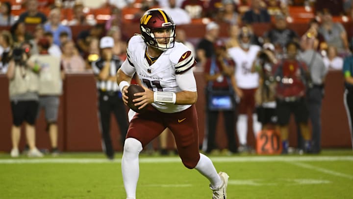 Aug 26, 2023; Landover, Maryland, USA; Washington Commanders quarterback Jake Fromm (11) rolls out