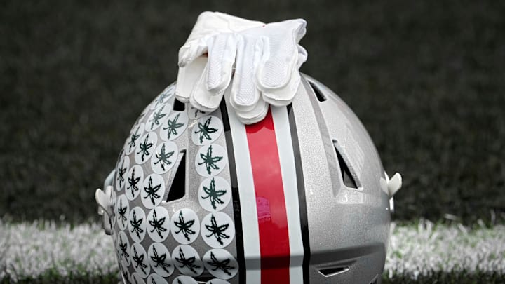 Oct. 14, 2023; Lafayette, In., USA; 
Gloves lie on top of the helmet of Ohio State Buckeyes wide receiver Julian Fleming (4) before Saturday's NCAA Division I football game against the Purdue Boilermakers at Ross-Ade Stadium in Lafayette.