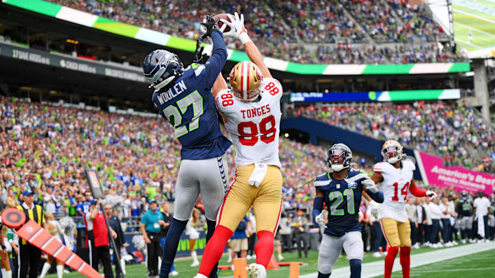 49ers tight end Jake Tonges (88) catches the ball for a touchdown being defended by Seahawks cornerback Riq Woolen (27)