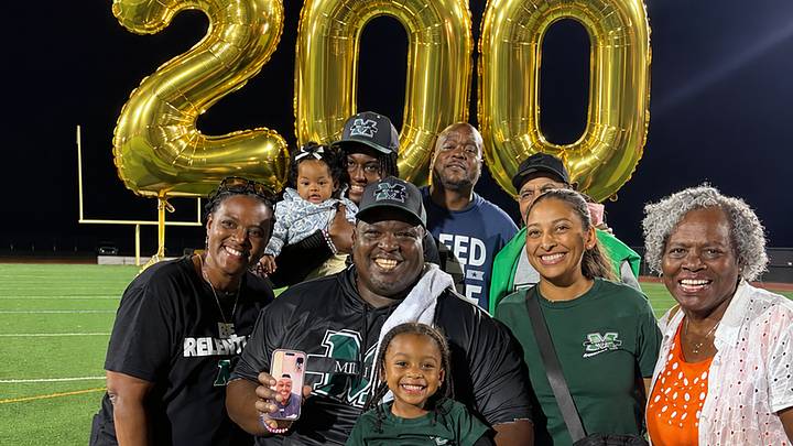 Surrounded by family and friends, Milford Mill head football coach Reggie White (center) celebrated career win No. 200 Friday night after his team's 52-6 win over Perry Hall. Surrounded by family and friends, Milford Mill head football coach Reggie White (center) celebrated career win No. 200 Friday night after his team's 52-6 win over Perry Hall.