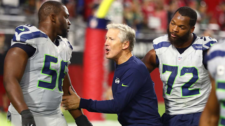 Oct 23, 2016; Glendale, AZ, USA; Seattle Seahawks defensive end Cliff Avril (56) and defensive end Michael Bennett (72) with head coach Pete Carroll against the Arizona Cardinals at University of Phoenix Stadium. The game ended in a 6-6 tie after overtime. Oct 23, 2016; Glendale, AZ, USA; Seattle Seahawks defensive end Cliff Avril (56) and defensive end Michael Bennett (72) with head coach Pete Carroll against the Arizona Cardinals at University of Phoenix Stadium. The game ended in a 6-6 tie after overtime.