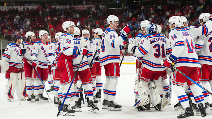 Nov 26, 2025; Raleigh, North Carolina, USA; New York Rangers players celebrate the win against the Carolina Hurricanes at Lenovo Center. Mandatory Credit: James Guillory-Imagn Images