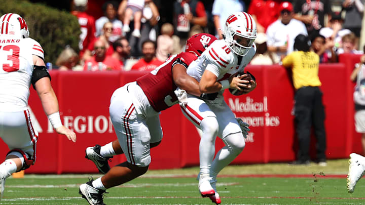 Sep 13, 2025; Tuscaloosa, Alabama, USA; Wisconsin Badgers quarterback Danny O'Neil (18) is sacked by Alabama Crimson Tide defensive lineman London Simmons (90) during the second quarter at Saban Field at Bryant-Denny Stadium. Mandatory Credit: David Leong-Imagn Images
