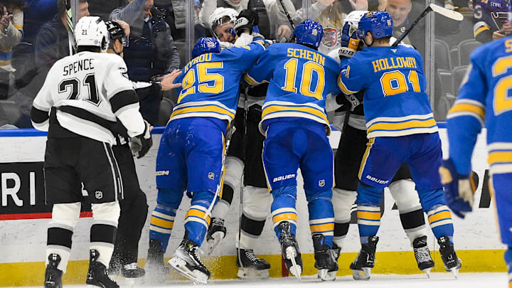 Mar 1, 2025; St. Louis, Missouri, USA;  St. Louis Blues center Jordan Kyrou (25) and Los Angeles Kings defenseman Jacob Moverare (43) fight during the third period at Enterprise Center. Mandatory Credit: Jeff Curry-Imagn Images