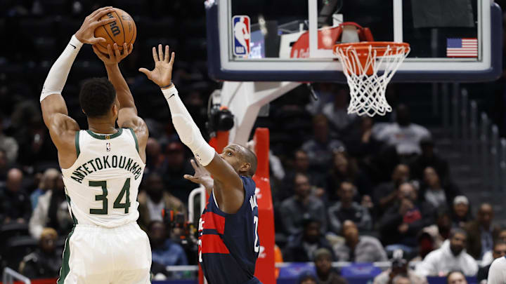 Dec 1, 2025; Washington, District of Columbia, USA; Milwaukee Bucks forward Giannis Antetokounmpo (34) shoots the ball over Washington Wizards forward Khris Middleton (22) in the second half at Capital One Arena. Mandatory Credit: Geoff Burke-Imagn Images