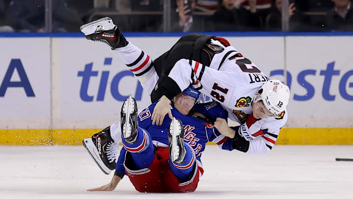 Mar 27, 2026; New York, New York, USA; Chicago Blackhawks center Sacha Boisvert (12) fights with New York Rangers defenseman Will Borgen (17) during the third period at Madison Square Garden. Mandatory Credit: Brad Penner-Imagn Images