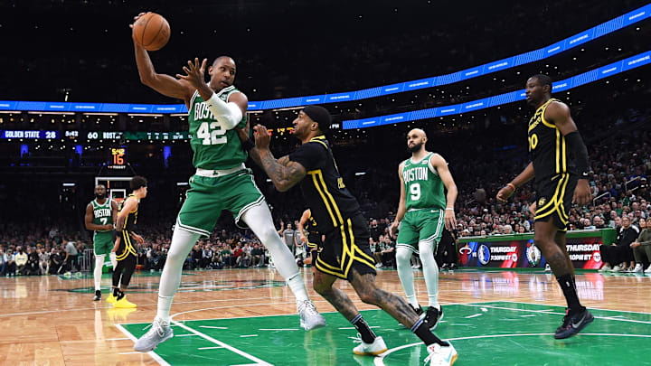 Mar 3, 2024; Boston, Massachusetts, USA: Boston Celtics center Al Horford (42) controls the ball while Golden State Warriors guard Gary Payton II (0) defends during the first half at TD Garden. Mandatory Credit: Bob DeChiara-Imagn Images