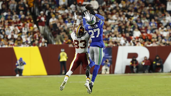 Nov 2, 2025; Landover, Maryland, USA; Seattle Seahawks cornerback Riq Woolen (27) attempts to intercept a pass for Washington Commanders wide receiver Jaylin Lane (83) during the third quarter at Northwest Stadium. Mandatory Credit: Geoff Burke-Imagn Images Nov 2, 2025; Landover, Maryland, USA; Seattle Seahawks cornerback Riq Woolen (27) attempts to intercept a pass for Washington Commanders wide receiver Jaylin Lane (83) during the third quarter at Northwest Stadium. Mandatory Credit: Geoff Burke-Imagn Images