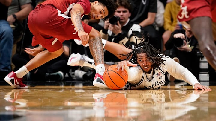 Vanderbilt forward Devin McGlockton (99) dives for a loose ball with Alabama guard Jalil Bethea (1) during the first half at Memorial Gymnasium in Nashville, Tenn., Wednesday, Jan. 7, 2026.