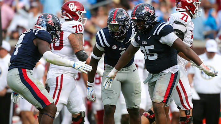 Oct 26, 2024; Oxford, Mississippi, USA; Mississippi Rebels linebacker Suntarine Perkins (4), defensive lineman Princely Umanmielen (1) and defensive lineman Akelo Stone (95) reacts after a sack during the second half  against the Oklahoma Sooners at Vaught-Hemingway Stadium. Mandatory Credit: Petre Thomas-Imagn Images