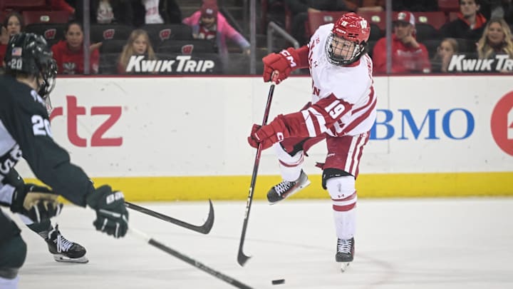 Wisconsin left wing Quinn Finley (19) fires a shot against Michigan State in the third period of a game Friday, January 16, 2026, at the Kohl Center in Madison, Wisconsin. Michigan State won, 4-1.