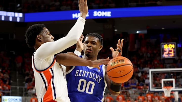 Feb 21, 2026; Auburn, Alabama, USA;  Kentucky Wildcats guard Otega Oweh (00) loses control of the ball as Auburn Tigers guard Kevin Overton (1) defends during the first half at Neville Arena. Mandatory Credit: John Reed-Imagn Images