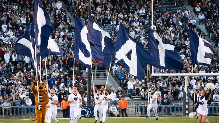 The Penn State Nittany Lion mascot and cheerleaders run across the field before a game against Michigan State at Beaver Stadium.