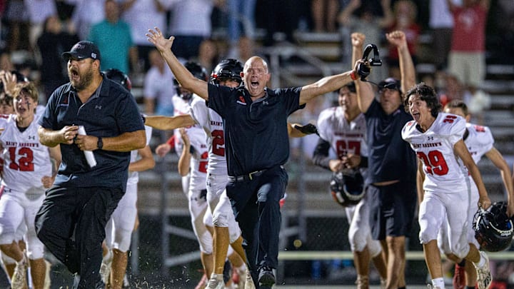 Saint Andrews head football coach Jimmy Robertson, center, celebrates with his team after they defeated West Boca Raton 10-7 in overtime  in West Boca Raton, Florida on September 8, 2023.