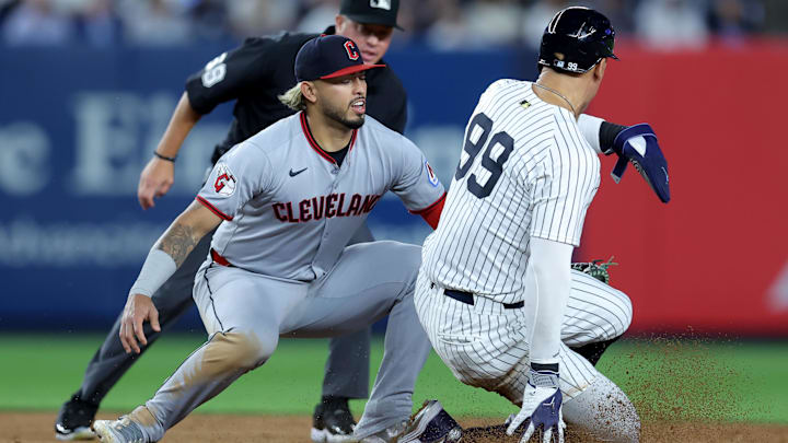 Jun 3, 2025; Bronx, New York, USA; Cleveland Guardians shortstop Gabriel Arias (13) tags out New York Yankees right fielder Aaron Judge (99) trying to steal second base during the eighth inning at Yankee Stadium. Mandatory Credit: Brad Penner-Imagn Images