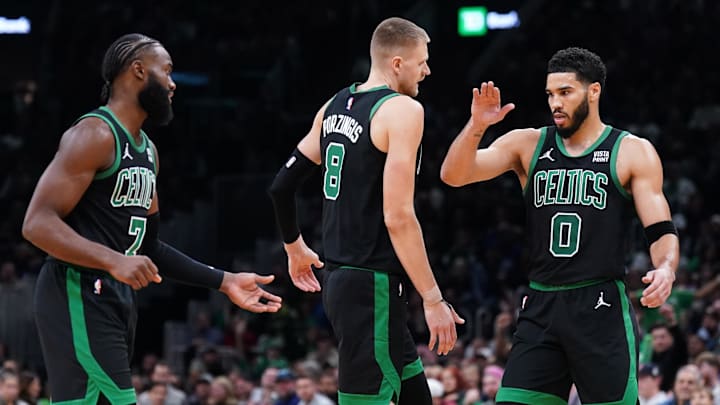 Nov 13, 2023; Boston, Massachusetts, USA; Boston Celtics forward Jayson Tatum (0), center Kristaps Porzingis (8) and guard Jaylen Brown (7) react after a play against th eNew York Knicks in the second quarter at TD Garden. Mandatory Credit: David Butler II-Imagn Images