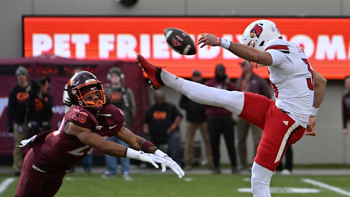 Nov 1, 2025; Blacksburg, Va.; Virginia Tech running back P.J. Prioleau (20) blocks a punt by Louisville's punter.
