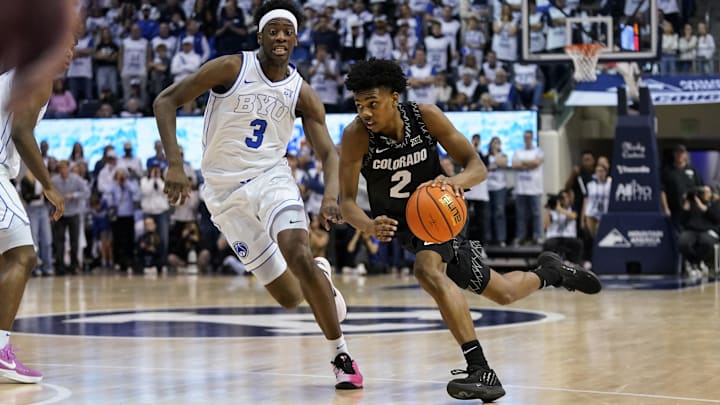 Feb 14, 2026; Provo, Utah, USA; Isaiah Johnson (2) of the Colorado Buffaloes drives while being defended by BYU Cougars forward AJ Dybantsa (3) during the second half at the Marriott Center. Mandatory Credit: Aaron Baker-Imagn Images