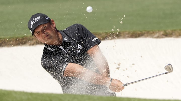 Patrick Reed plays a shot from a bunker during the final round of The Masters