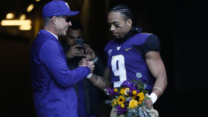 Myles Gaskin goes through 2018 senior day festivities with then UW coach Chris Petersen. 