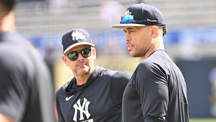 Feb 16, 2026; Tampa, FL, USA; New York Yankees manager Aaron Boone (17) talks with outfielder Giancarlo Stanton (27) during spring training at George M. Steinbrenner Field. Mandatory Credit: Jonathan Dyer-Imagn Images
