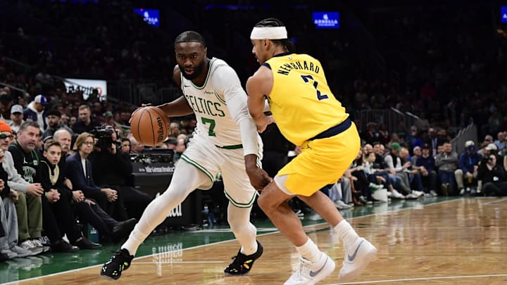 Dec 22, 2025; Boston, Massachusetts, USA; Boston Celtics guard Jaylen Brown (7) controls the ball while Indiana Pacers guard Andrew Nembhard (2) defends during the first half at TD Garden. Mandatory Credit: Bob DeChiara-Imagn Images
