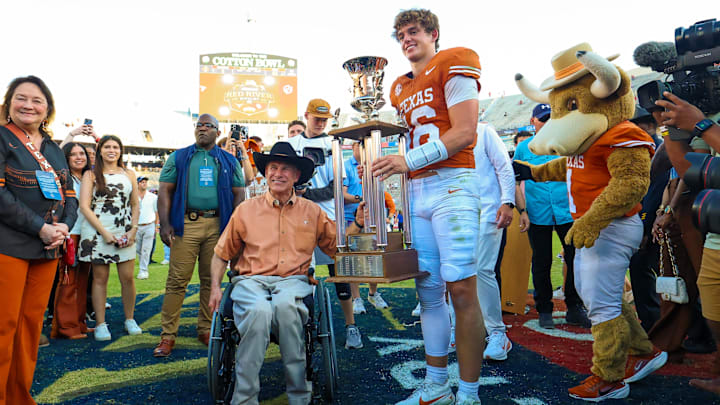Oct 11, 2025; Dallas, Texas, USA; Texas Governor Greg Abbott pose for a photo with Texas Longhorns quarterback Arch Manning (16) after the game against the Oklahoma Sooners at the Cotton Bowl. Mandatory Credit: Kevin Jairaj-Imagn Images