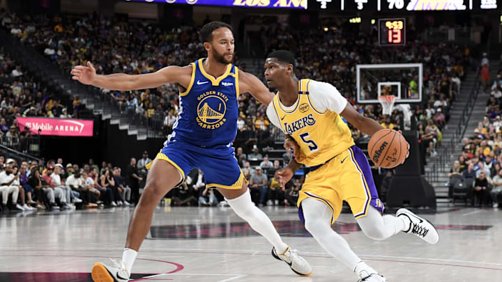 Oct 15, 2024; Las Vegas, Nevada, USA; Los Angeles Lakers forward Cam Reddish (5) drives past Golden State Warriors forward Kyle Anderson (1) in the fourth quarter of their preseason game  at T-Mobile Arena. Mandatory Credit: Candice Ward-Imagn Images