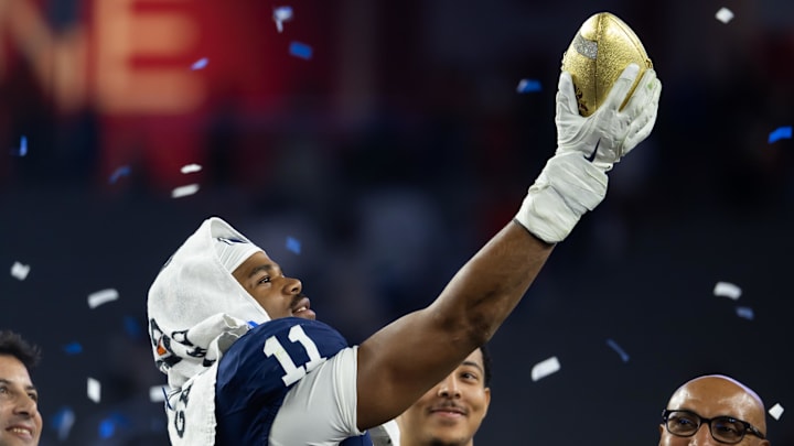 Penn State Nittany Lions defensive end Abdul Carter celebrates with the trophy after defeating the Boise State Broncos in the Fiesta Bowl at State Farm Stadium. 