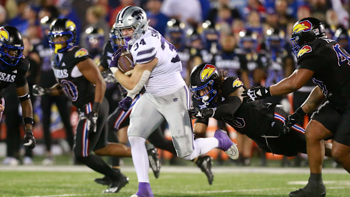 Kansas State junior tight end Ben Sinnott (34) drives through Kansas defenders during the first quarter of Saturday's Sunflower Showdown against Kansas inside David Booth Kansas Memorial Stadium.
