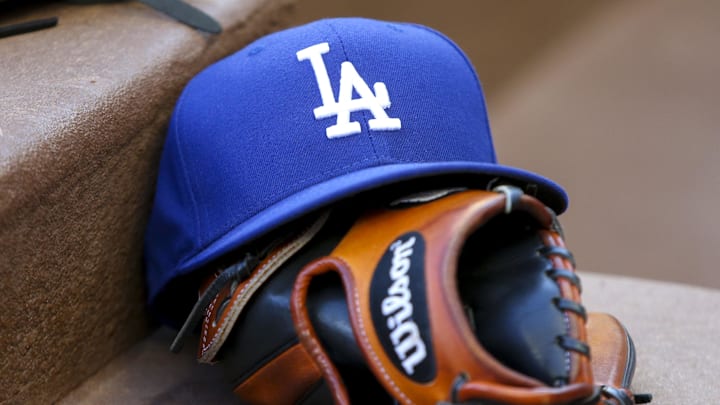 Aug 16, 2019; Atlanta, GA, USA; Detailed view of Los Angeles Dodgers hat and glove in the dugout against the Atlanta Braves in the first inning at SunTrust Park. Mandatory Credit: Brett Davis-Imagn Images