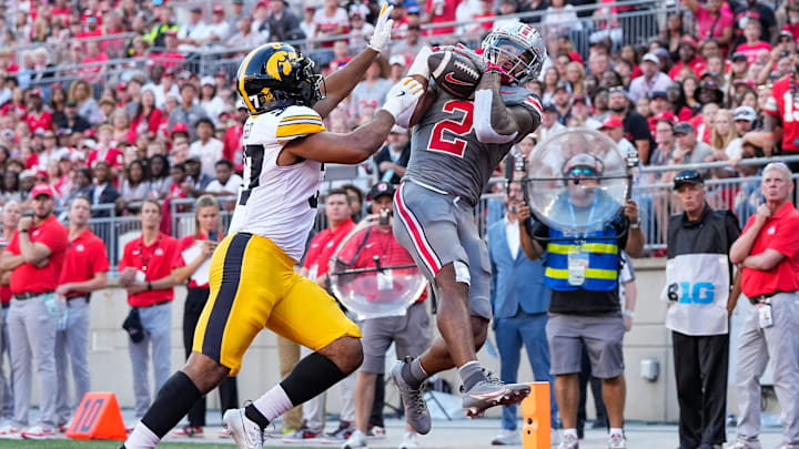 Oct 5, 2024; Columbus, OH, USA; Ohio State Buckeyes wide receiver Emeka Egbuka (2) catches a touchdown in front of Iowa Hawkeyes linebacker Kyler Fisher (37) during the second half of the NCAA football game at Ohio Stadium. Ohio State won 35-7.