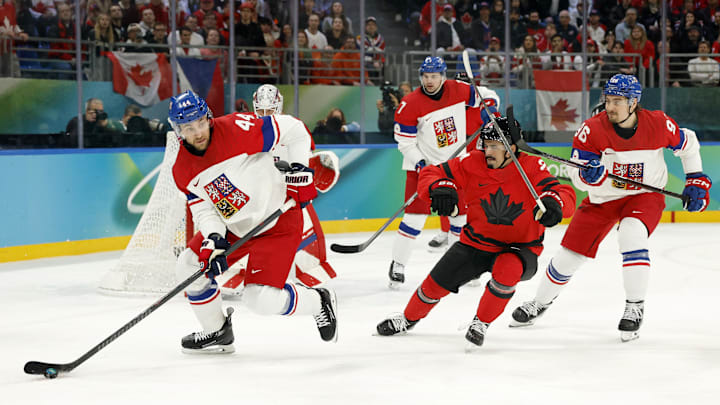Feb 18, 2026; Milan, Italy; Jan Rutta of Czechia controls the puck against Seth Jarvis of Canada in a men's ice hockey quarterfinal during the Milano Cortina 2026 Olympic Winter Games at Milano Santagiulia Ice Hockey Arena. Mandatory Credit: Geoff Burke-Imagn Images