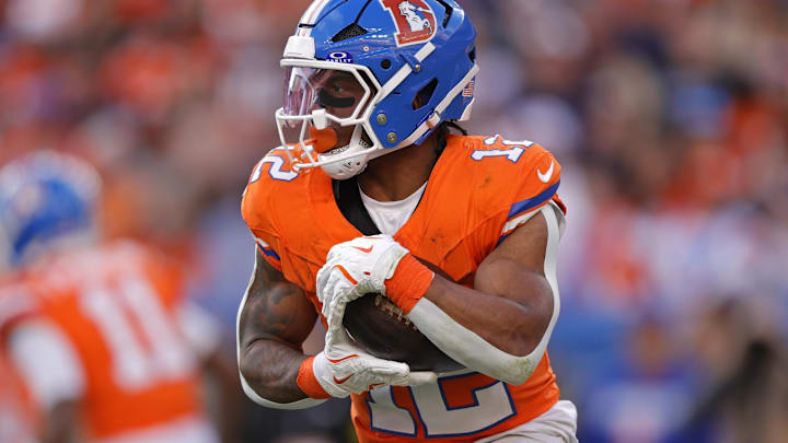 Jan 4, 2026; Denver, Colorado, USA; Denver Broncos running back RJ Harvey (12) runs with the ball during the game against the Los Angeles Chargers during the first half at Empower Field at Mile High