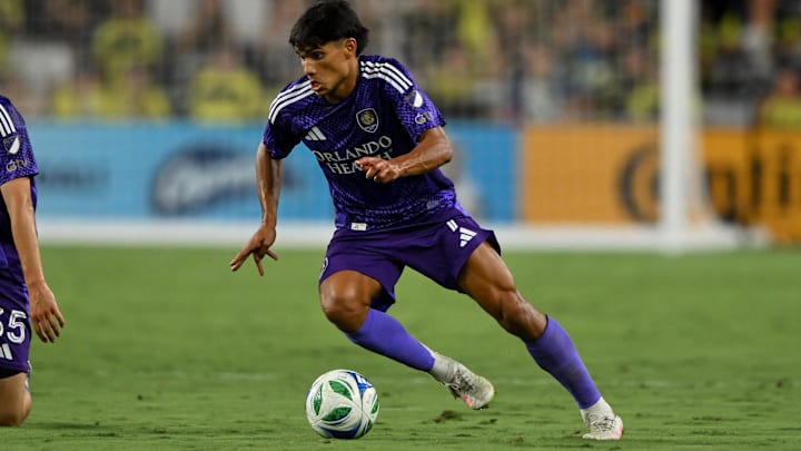 Aug 23, 2025; Nashville, Tennessee, USA;  Orlando City forward Ramiro Enrique (7) dribbles the ball against the Nashville SC during the first half at Geodis Park. Mandatory Credit: Steve Roberts-Imagn Images